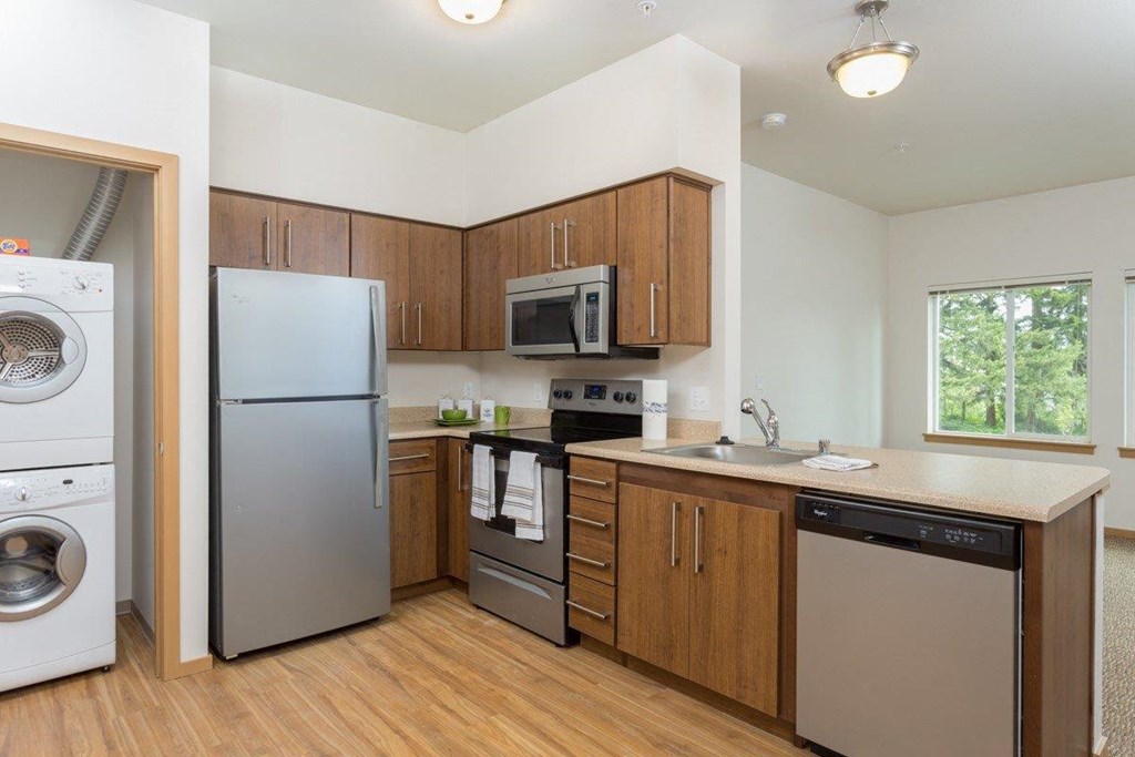 a kitchen with stainless steel appliances and wooden cabinets
