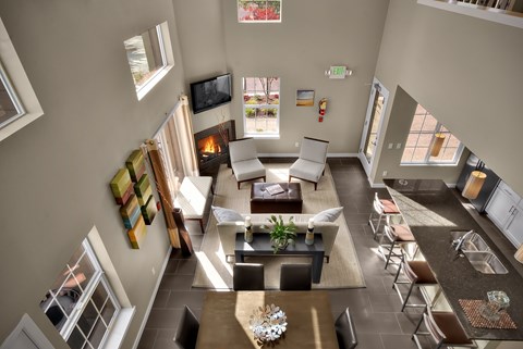A living room with a fireplace and a flat screen TV.