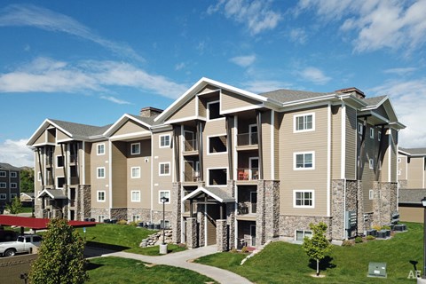 an exterior view of an apartment building on a sunny day