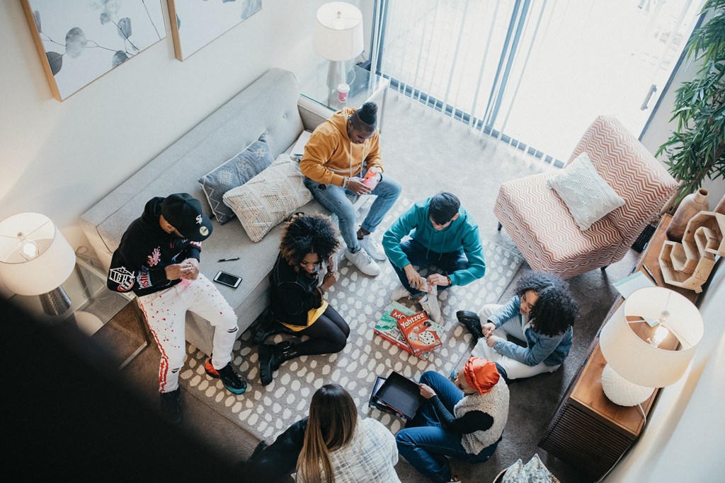 Residents sit playing games at Sundance apartments.
