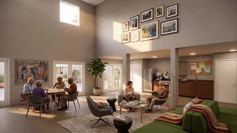 A group of people are sitting around a table in a room.