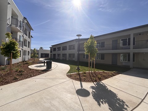 A sunny day at a residential complex with a clear blue sky.