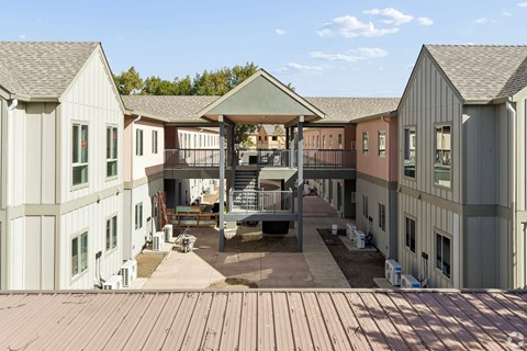 A large building with a patio and a gazebo in the middle.