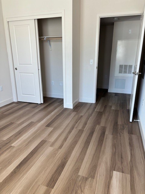 A room with a white door and a white closet with a white door.