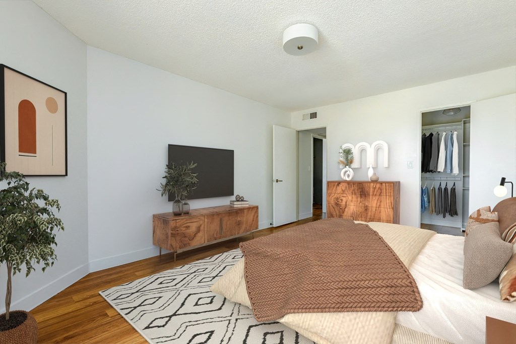 a bedroom with a large bed and a tv in the corner