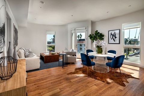 a living room with a dining room table and a couch