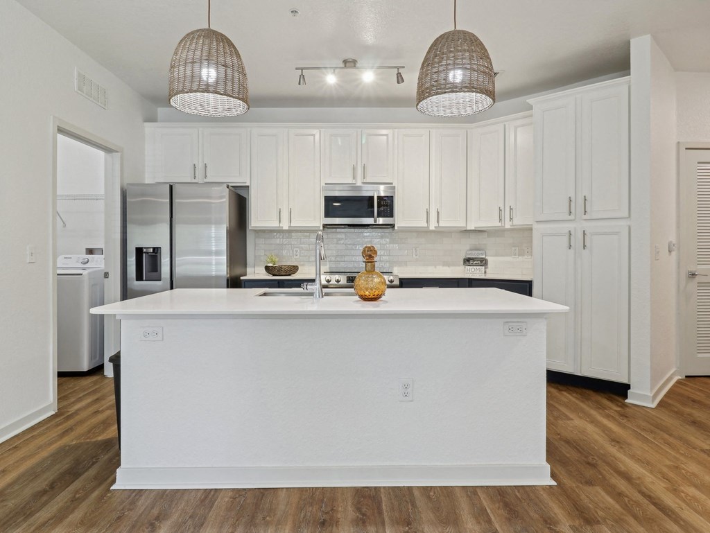 a kitchen with white cabinets and a white counter top