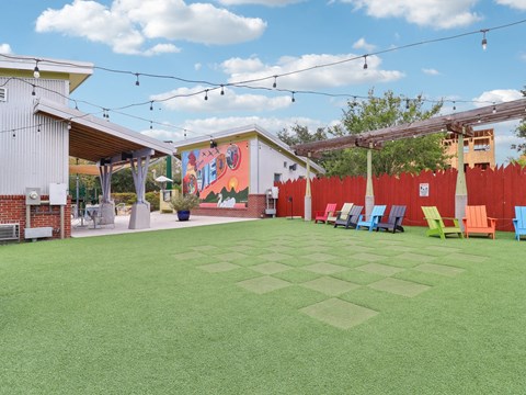 Yard with chairs and a mural on the side of a building  at Park Place, Oviedo, FL, 32765