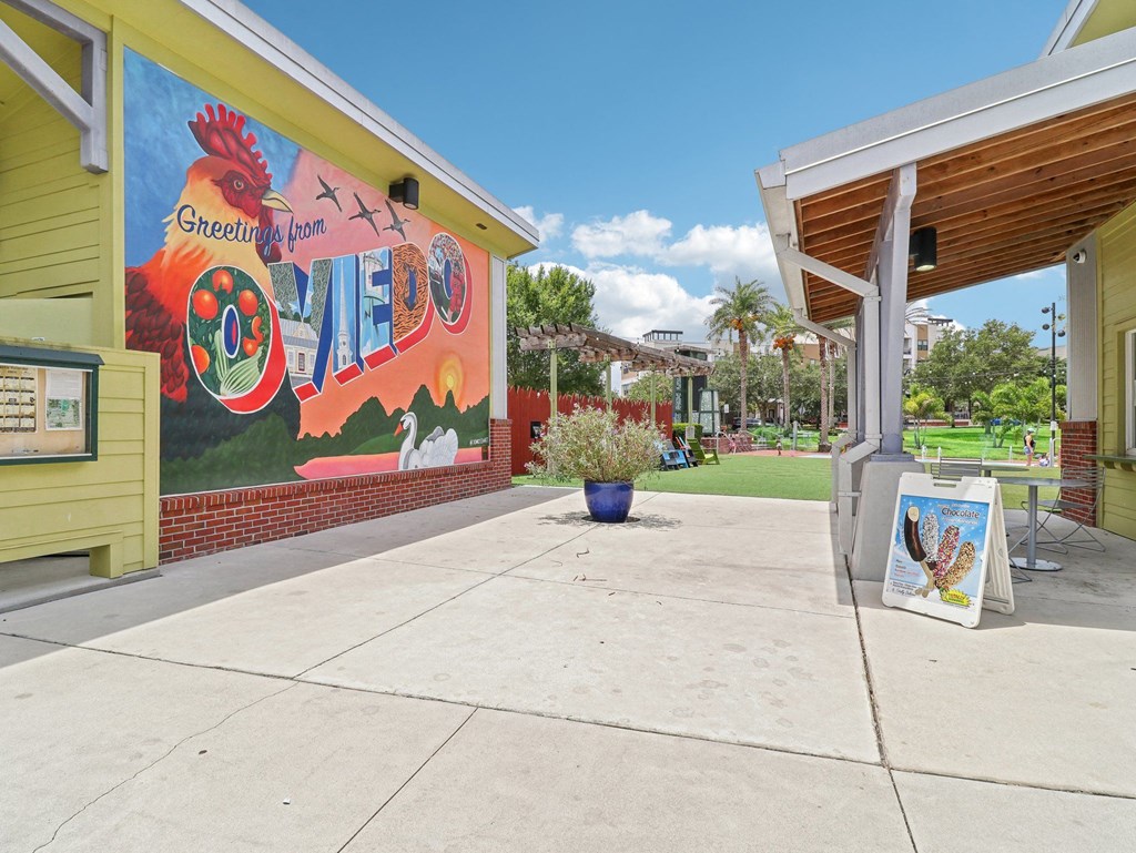 a mural on the side of a building with a sidewalk