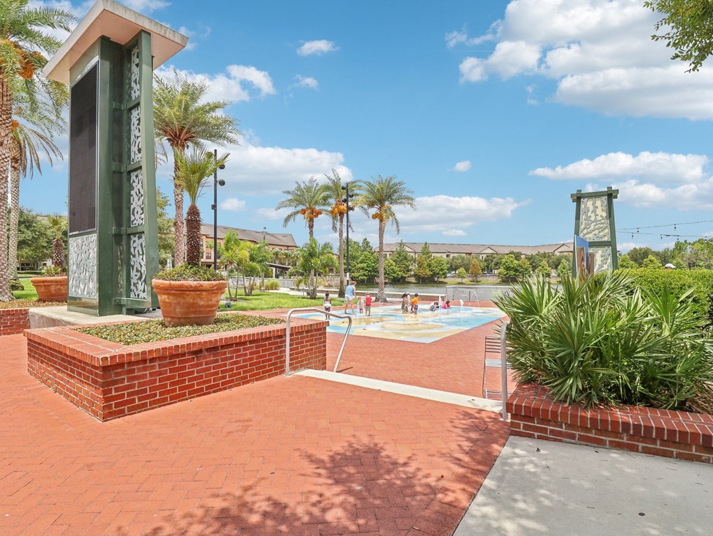 a swimming pool with palm trees and a building in the background