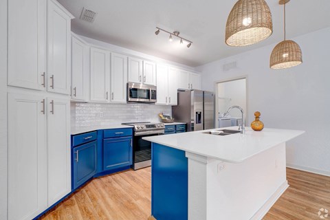 Kitchen with blue and white cabinets and a white counter top  at Park Place, Oviedo, FL, 32765