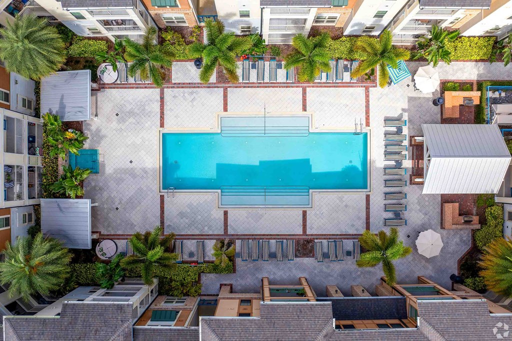 a swimming pool in the middle of a building with palm trees