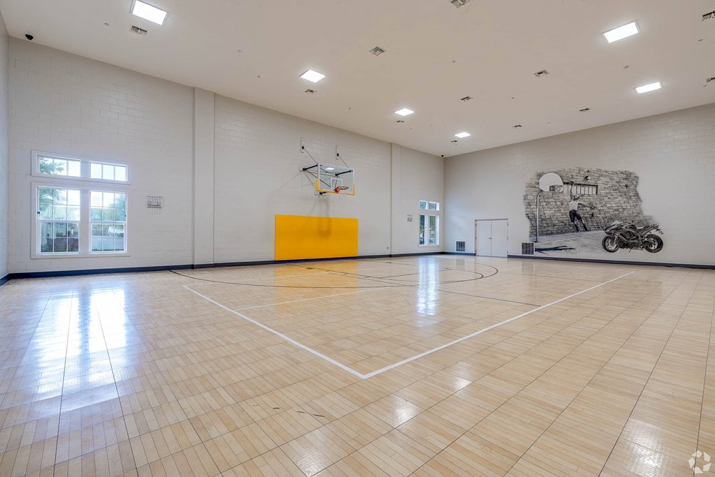 a basketball court in the center of a large room
