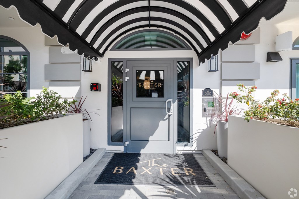 the entrance to the battersea hotel with a black and white canopy above the door