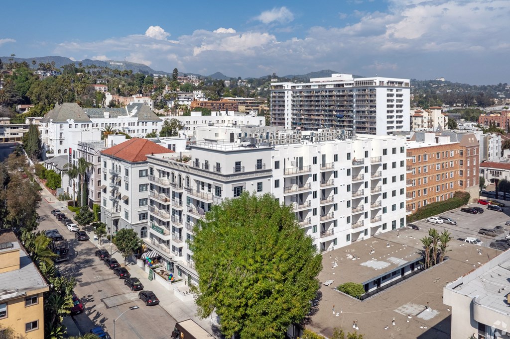 an aerial view of a city with tall buildings and trees