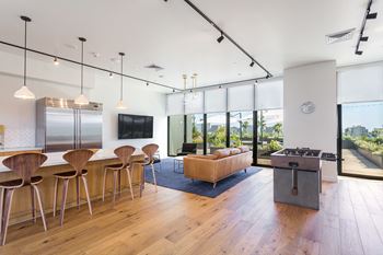 An open living room with a kitchen and dining area at Mariposa on 3rd, Los Angeles, CA 90004