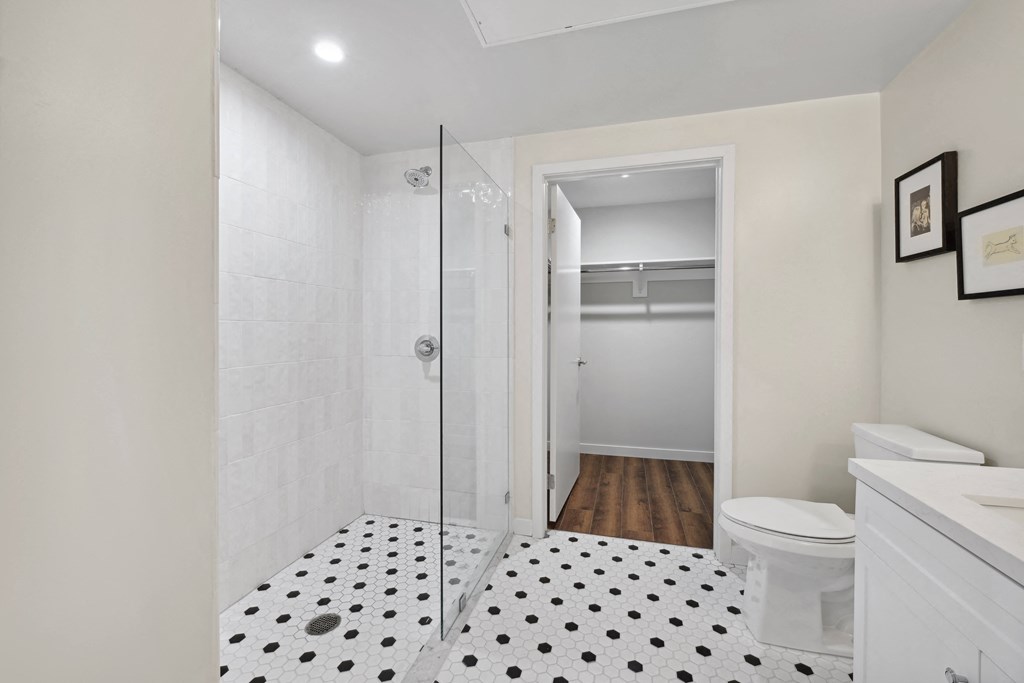 a bathroom with a glass shower and a toilet