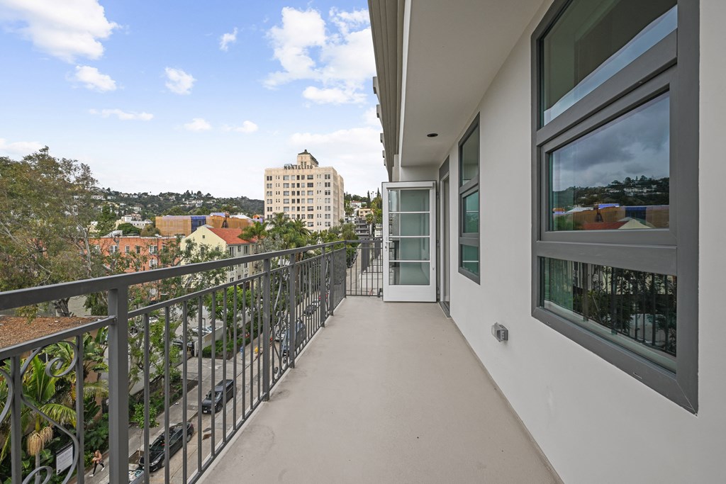 a long balcony with a view of the city