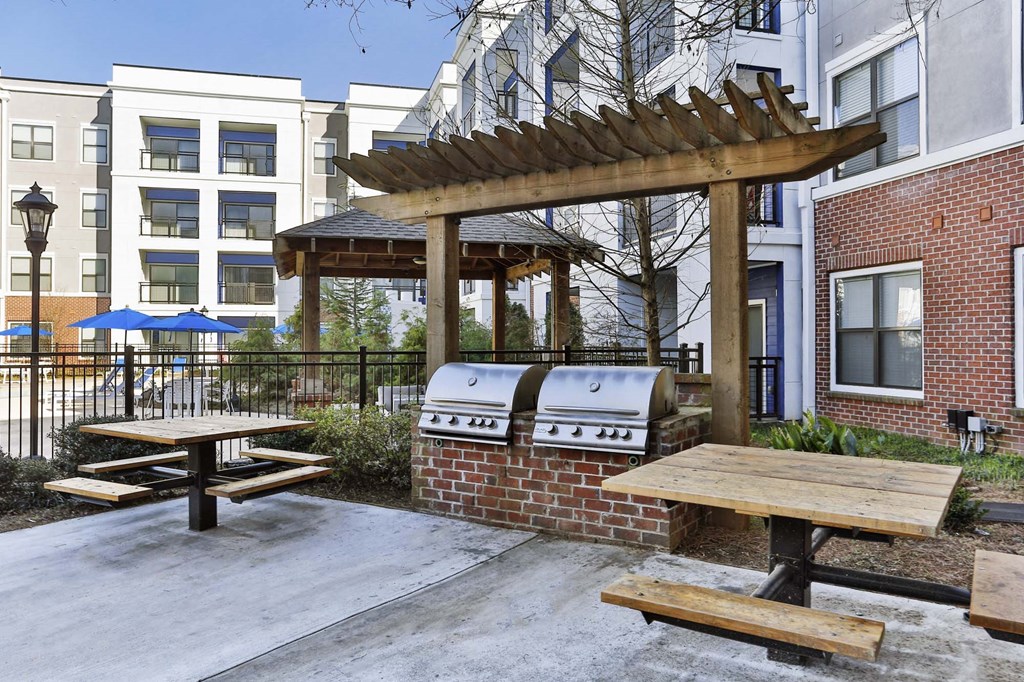grilling area and apartment building on sunny day  at The Brookhaven Collection, Georgia