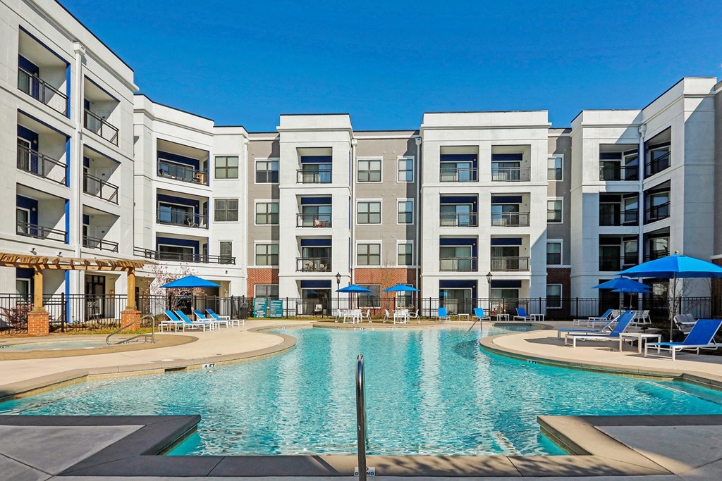 furnished pool area and aparmtent building on sunny day  at The Brookhaven Collection, Georgia
