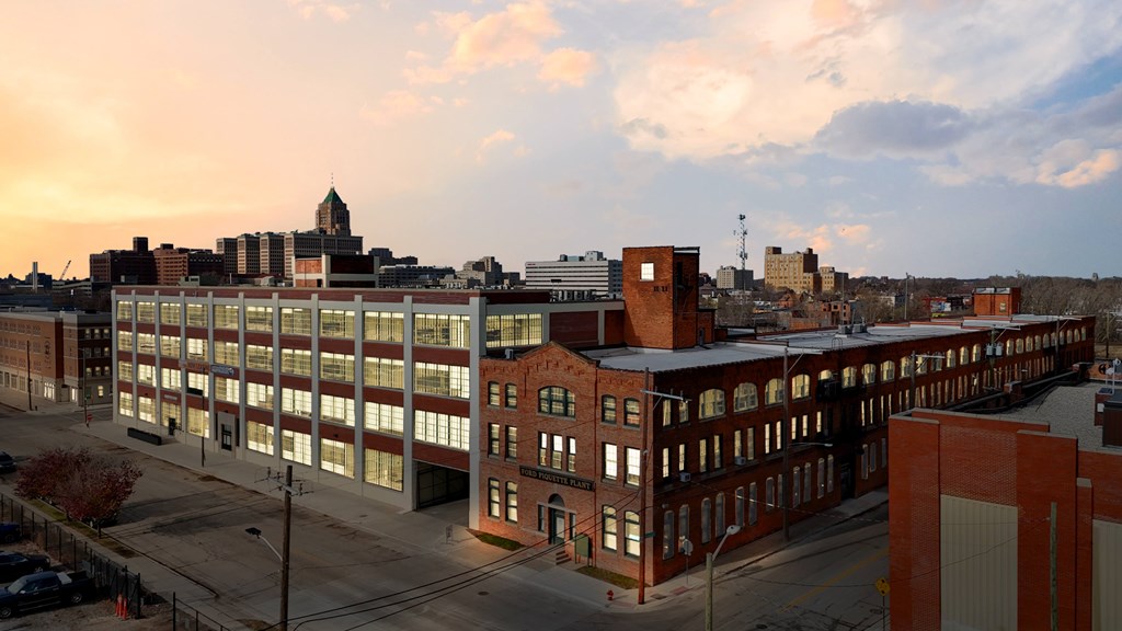 A large building with a lot of windows is in the foreground.