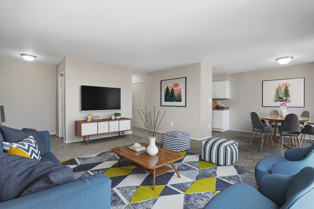 our apartments offer a living room with a couch a coffee table and a dining table
