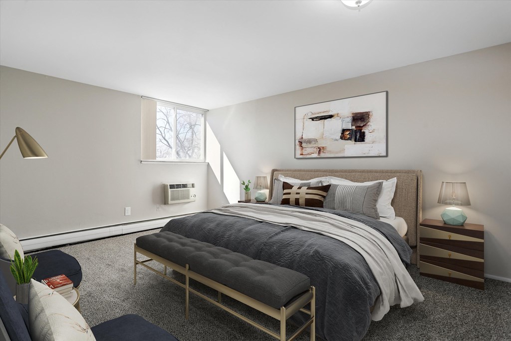 a bedroom with a bed and a chair in a 555 waverly unit
