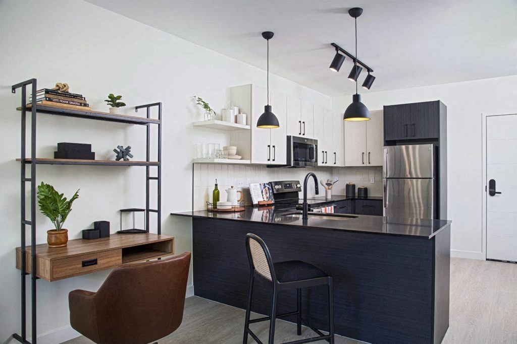 a kitchen and dining area with a black counter top