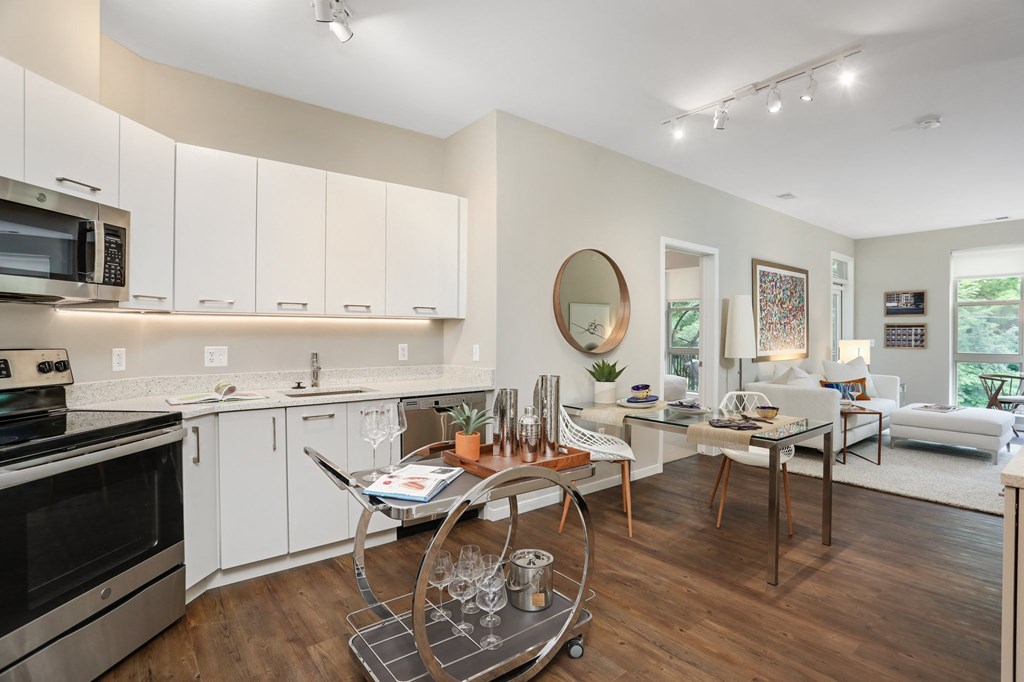 a kitchen and living room with a table and chairs