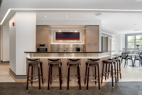 a large kitchen with a bar and stools