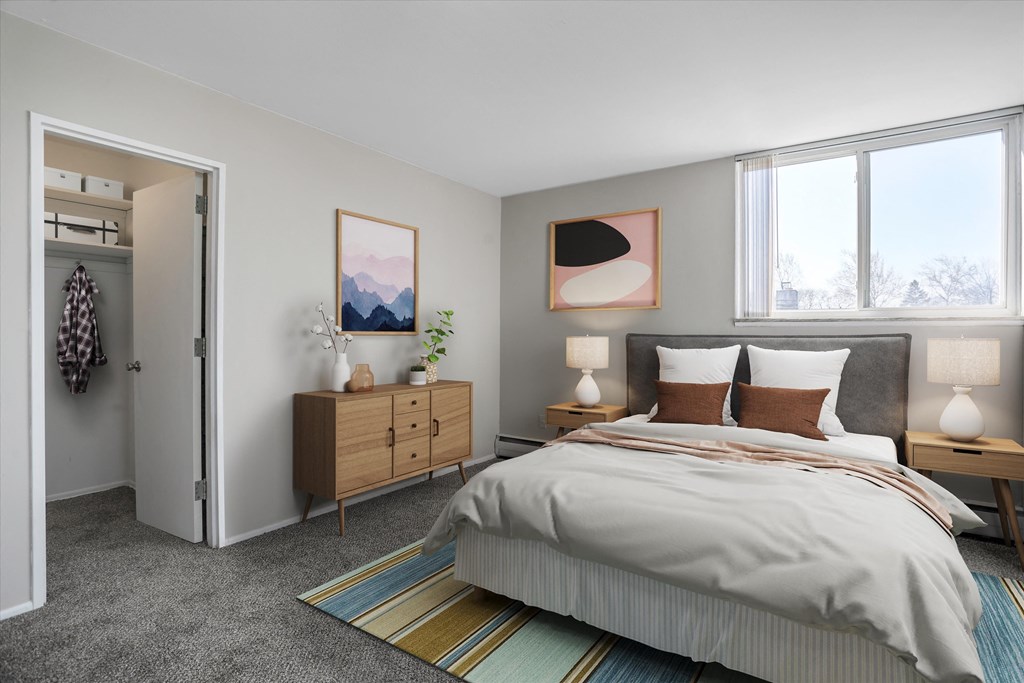 a bedroom with a bed and a dresser in a 555 waverly unit