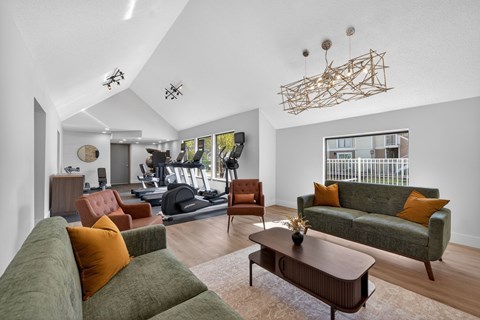 A living room with a green couch and a wooden coffee table.