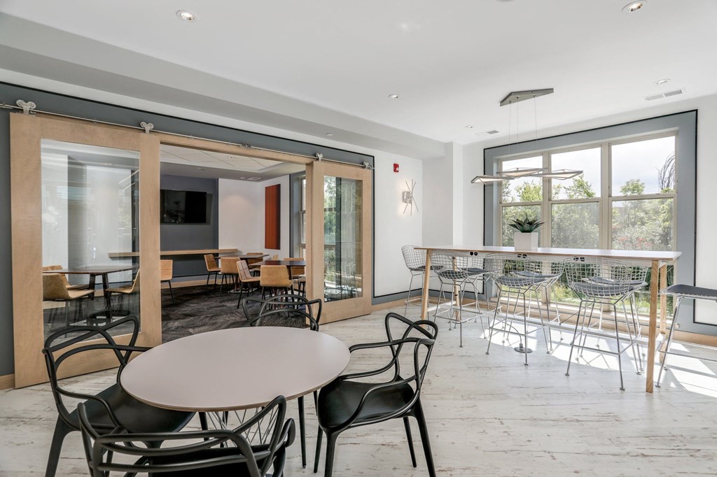 a dining room with tables and chairs and a large window