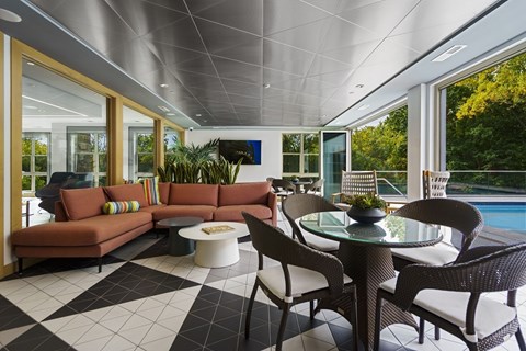 A modern living room with a pool outside.