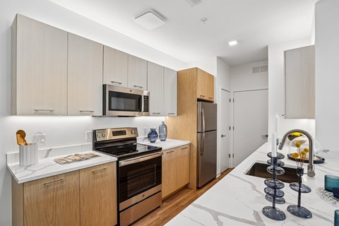 A modern kitchen with wooden cabinets and stainless steel appliances.
