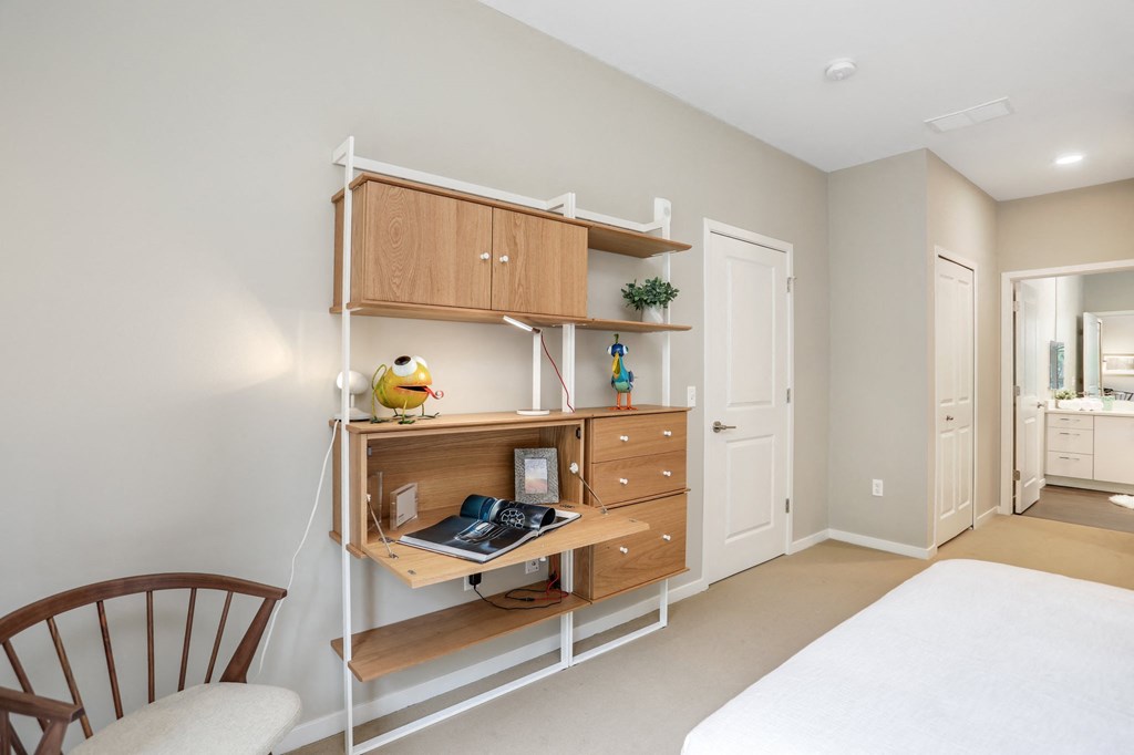 a home office with a desk and a chair in a living room