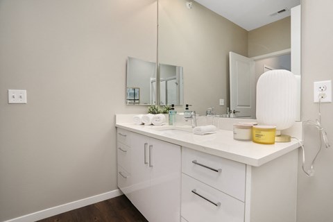 a white bathroom with a large mirror and a sink