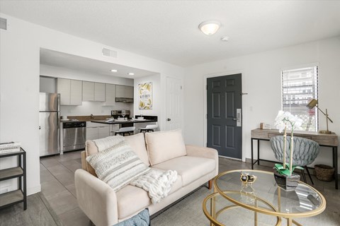 a living room with a couch and a glass table