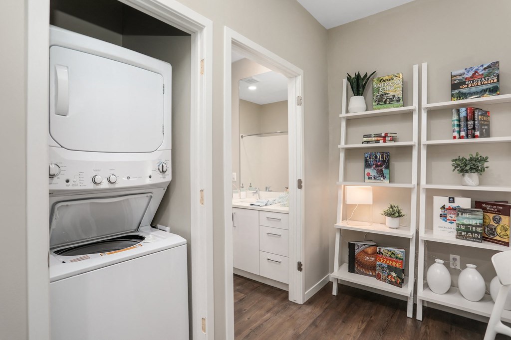 a laundry room with a washer and dryer next to a closet