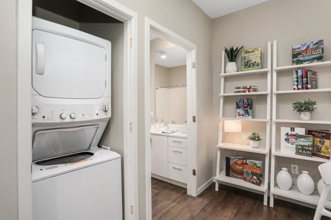 a laundry room with a washer and dryer next to a closet