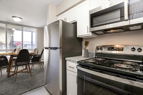 a kitchen with stainless steel appliances and a stove and refrigerator