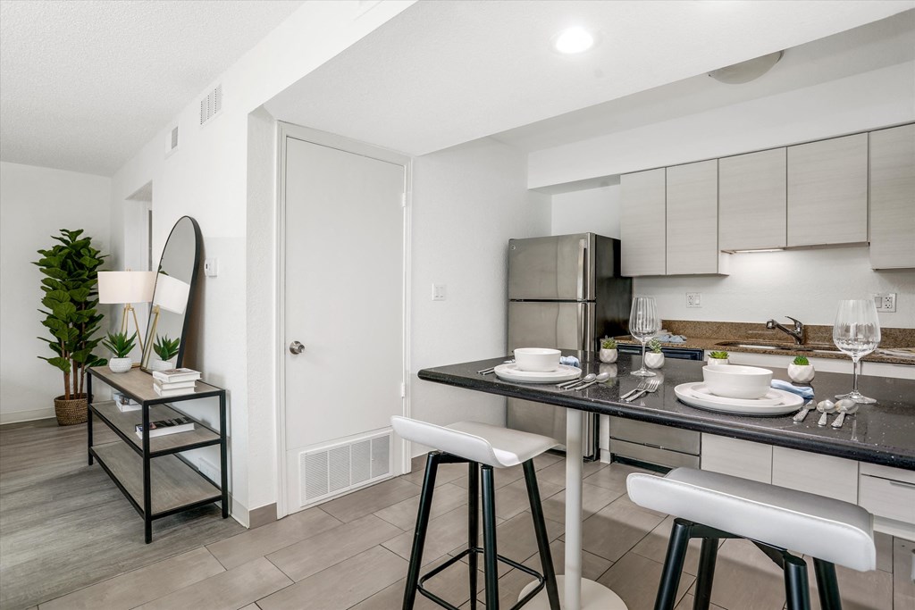 an open kitchen and dining room with a bar and stools