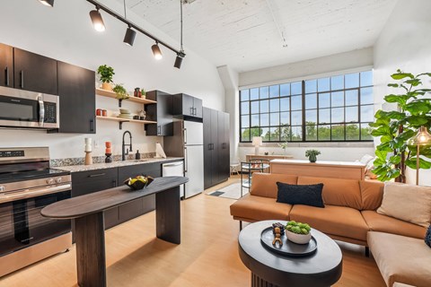 A modern kitchen with a dining table and a couch.