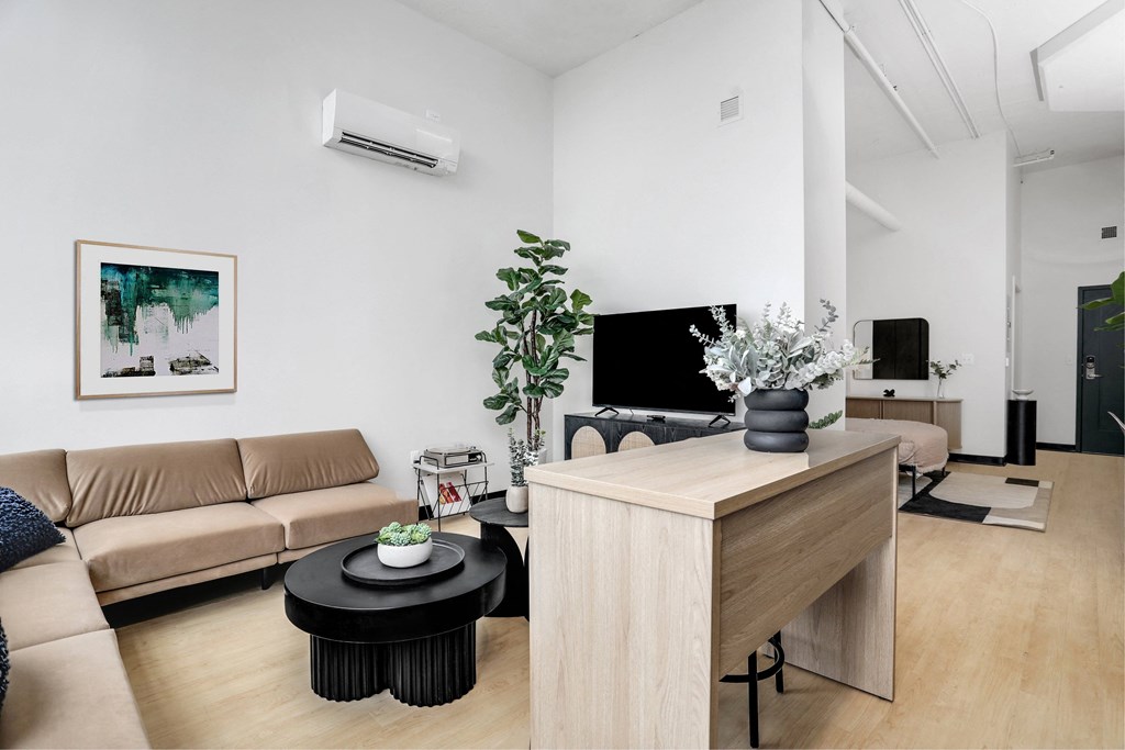 a living room with a couch and a table and a tv