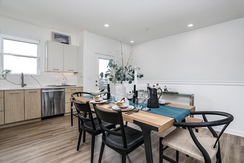 A kitchen with a table and chairs set for two.