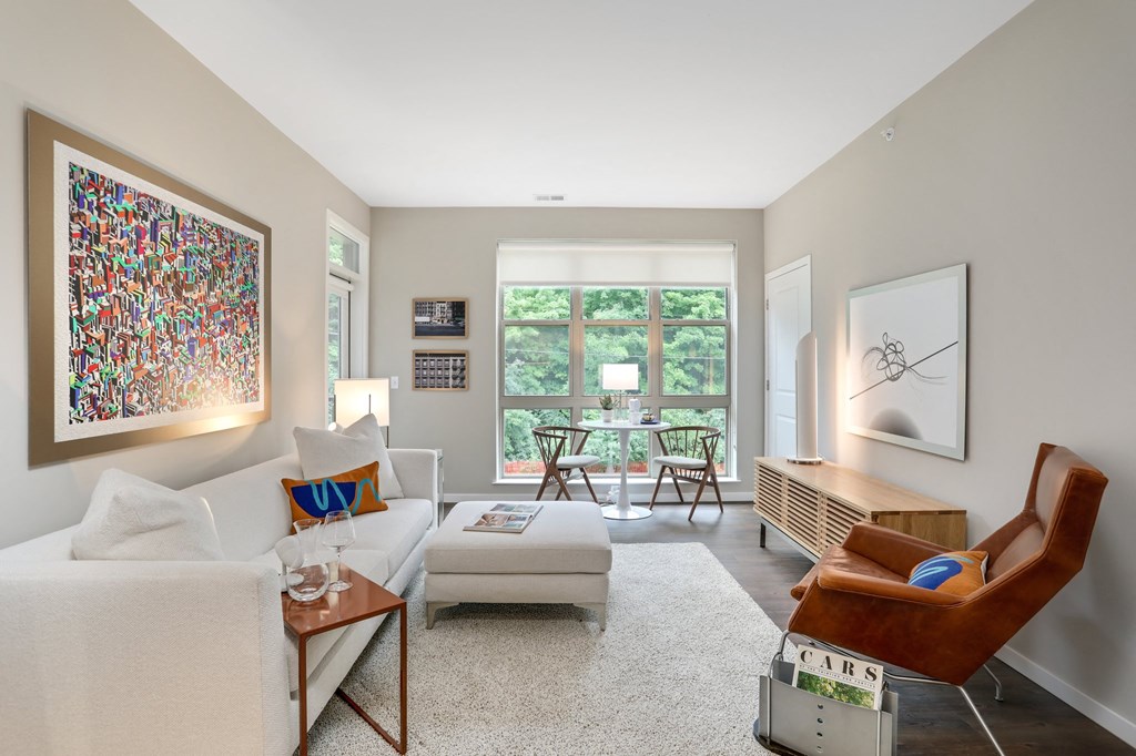 a living room with two couches and a table and a window