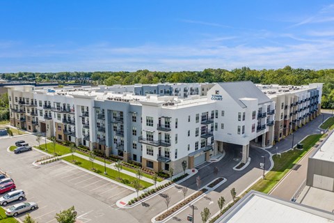 an aerial view of an apartment building with cars parked in front of it