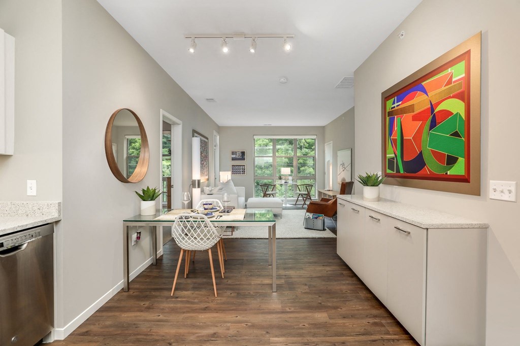 a kitchen with a counter top and a table with a chair