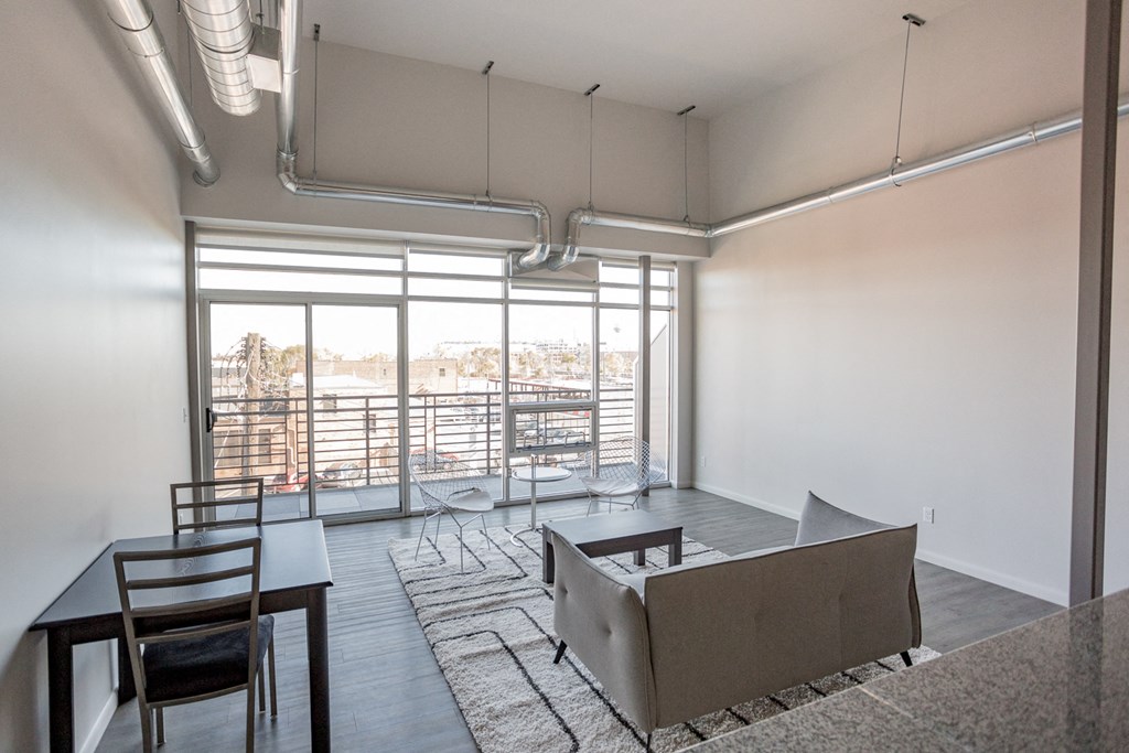 A room with a table and chairs and a couch.