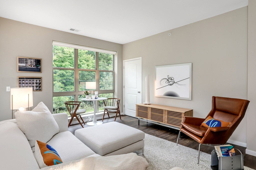a living room with a white couch and a large window